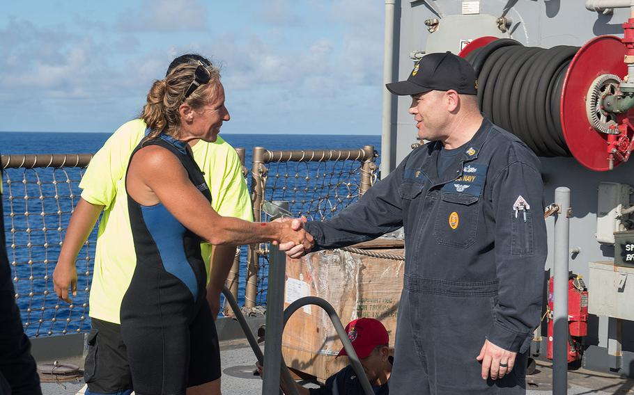 USS Ashland (LSD 48) Command Master Chief Gary Wise welcomes aboard Jennifer Appel, an American mariner who had received assistance from Ashland crew members.