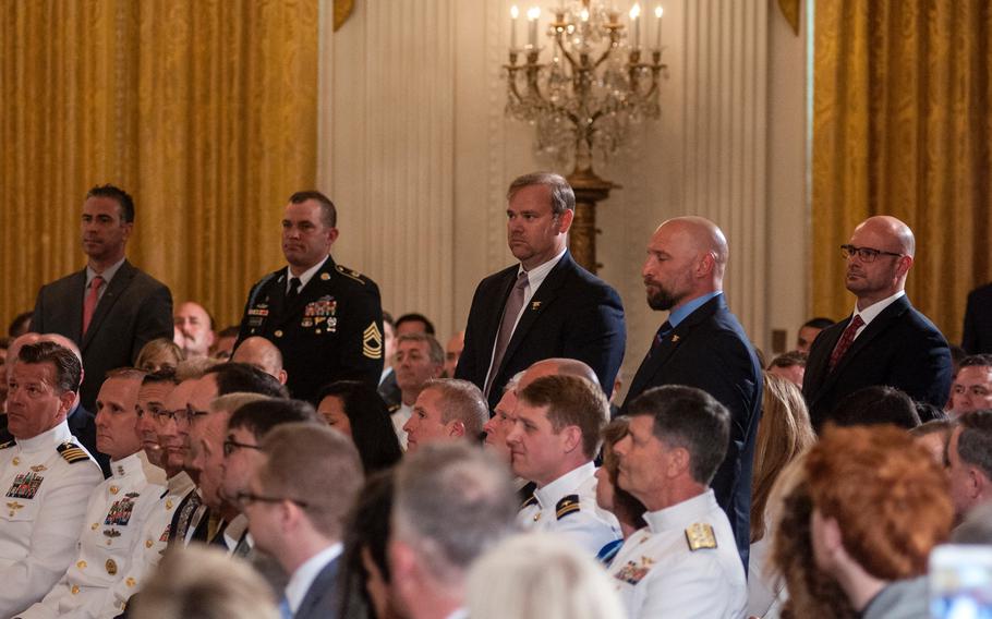 During a ceremony Thursday, May 24, 2018, at the White House, where retired Navy SEAL Master Chief Petty Officer Britt Slabinski received the Medal of Honor for his actions during a March 2002 Afghanistan battle, President Donald Trump recognized seven other members of Slabinski's Special Forces team, five of whom stood to be recognized. The seven named were Petty Officer 2nd Class Brett Morganti, Chief Warrant Officer Kyle Soderberg, Petty Officer 2nd Class Stephen Toboz, Chief Warrant Officer Al Mack, Sergeant Christopher Cunningham, Master Sergeant Eric Stebner and an unnamed Master Chief Petty Officer still on active duty who was "quietly not with us today," said the president.
