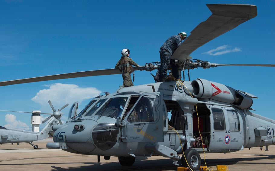  In anticipation of the arrival of Hurricane Florence, Sailors of Helicopter Sea Combat Squadron (HSC) 28 prepare MH-60S Sea Hawk helicopters to evacuate Naval Station Norfolk on Sept. 11, 2018.