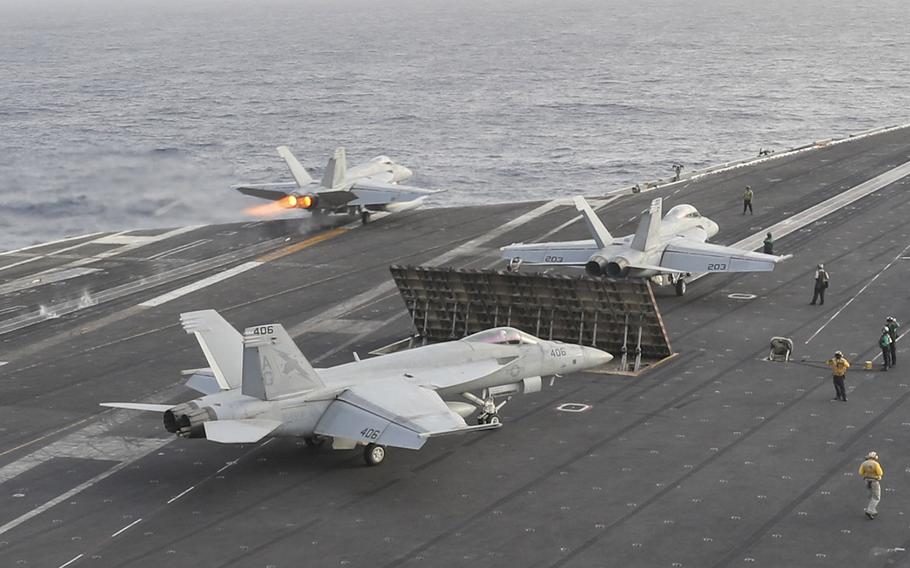 An F/A-18E Super Hornet from the "Pukin' Dogs" of Strike Fighter Squadron 143 launches from the flight deck of the Nimitz-class aircraft carrier USS Abraham Lincoln on June 22, 2019.