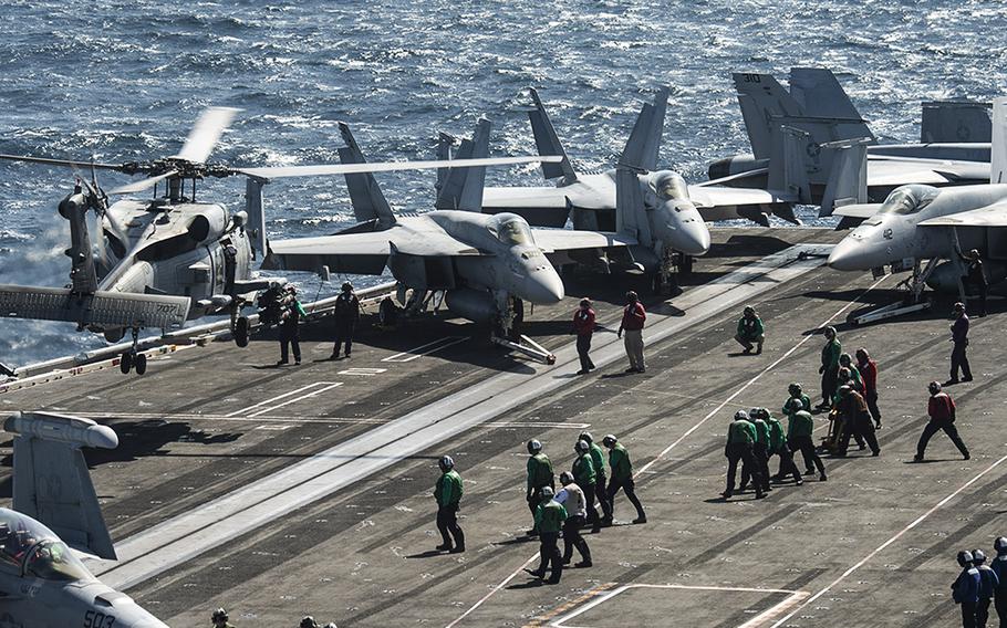 An MH-60R Sea Hawk helicopter, attached to the “Proud Warriors” of Helicopter Maritime Strike Squadron (HSM) 72, lands on the flight deck of the USS Harry S. Truman while transiting the Bab al-Mandeb Strait on Dec. 17, 2019. The Navy had planned to decommission the carrier in 2024, but reversed that decision.