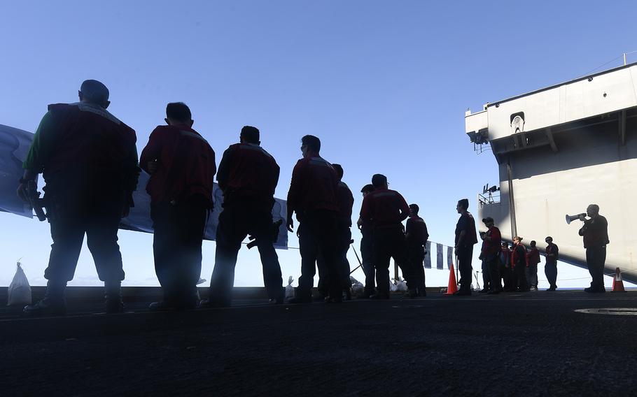 Personnel aboard the aircraft carrier USS Theodore Roosevelt (CVN 71) prepare for small arms qualifications on March 22, 2020, while transiting the Philippine Sea. 