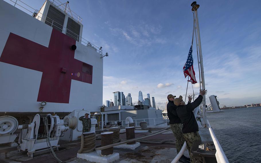 Sailors participate in a morning colors ceremony aboard the hospital ship USNS Comfort on April 1, 2020, while the ship is moored in New York City in support of the nation's COVID-19 response efforts.