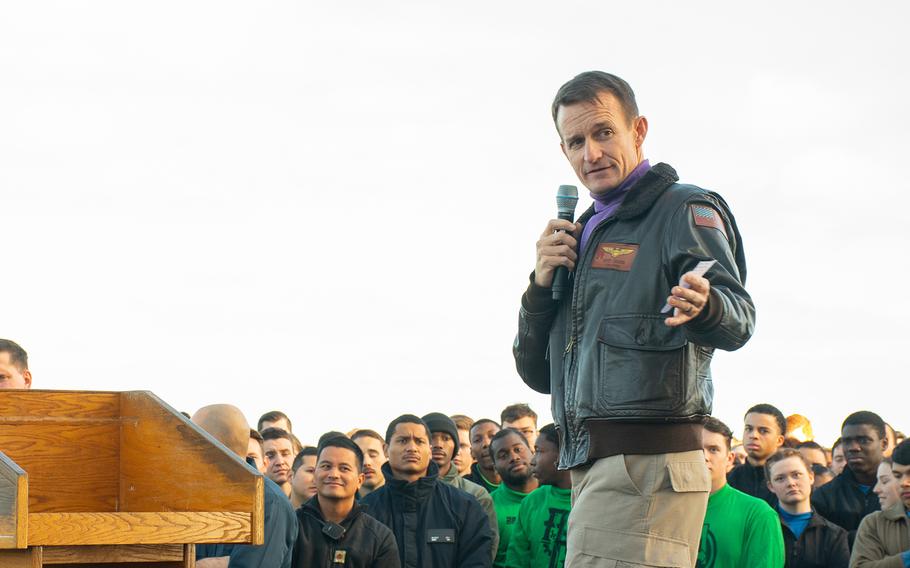 Capt. Brett Crozier, then-commanding officer of the aircraft carrier USS Theodore Roosevelt (CVN 71), speaks to the crew on the ship's flight deck on Dec. 15, 2019, while operating in the Pacific Ocean. Navy leaders on Friday, April 24, 2020, recommended that Crozier be reinstated following their investigation into his letter warning of a severe coronavirus outbreak on the carrier.