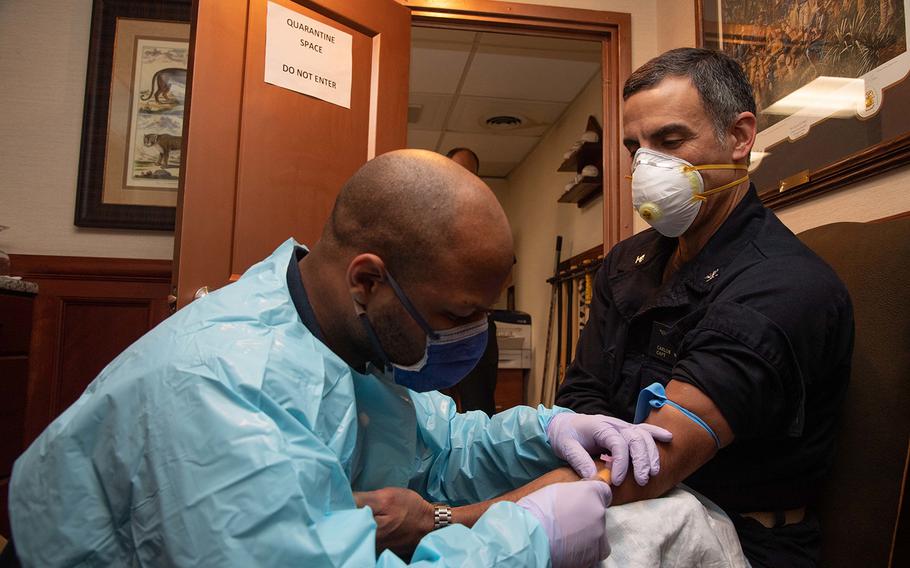 U.S. Navy Capt. Carlos Sardiello, commanding officer of the aircraft carrier USS Theodore Roosevelt (CVN 71), gives blood for a serology study aimed at identifying antibodies associated with COVID-19 aboard the ship on April 22, 2020. 
