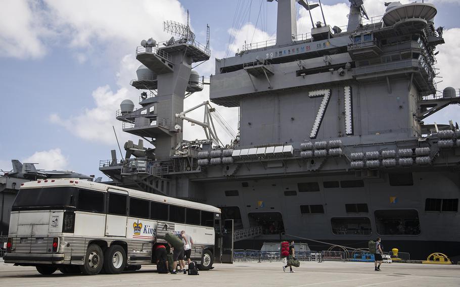 Sailors assigned to the aircraft carrier USS Theodore Roosevelt prepare to embark the ship at Naval Base Guam on April 29, 2020. 