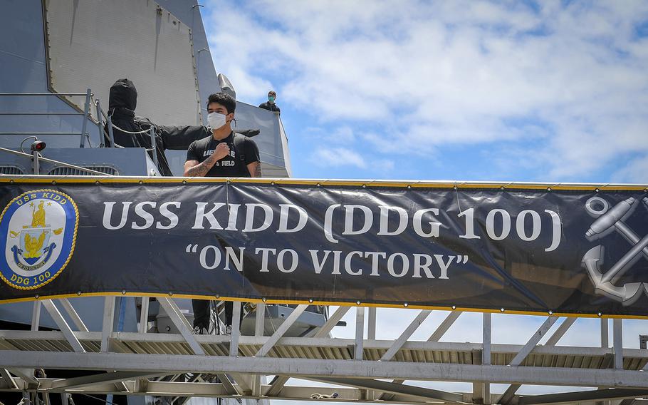 A sailor returns to the guided-missile destroyer USS Kidd at Naval Base San Diego after completing a coronavirus quarantine, June 5, 2020.