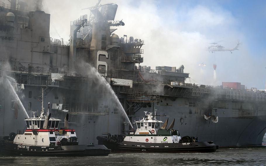 Fire crews battle a blaze aboard the amphibious assault ship USS Bonhomme Richard at Naval Base San Diego, July 13, 2020. 