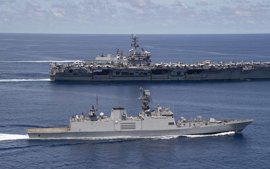 The aircraft carrier USS Nimitz steams beside a ship from the Indian navy in the Indian Ocean on Monday, July 20, 2020.
