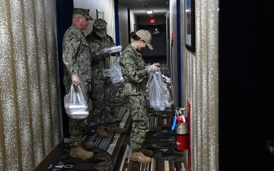 Sailors deliver meals to personnel in a Restriction of Movement status at Naval Air Facility Misawa on March 26, 2020. 