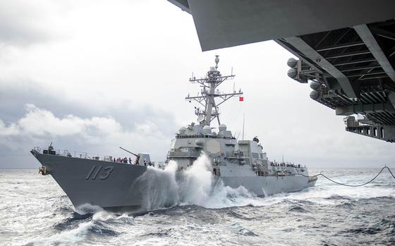 The guided-missile destroyer USS John Finn approaches the aircraft carrier USS Theodore Roosevelt for a replenishment-at-sea somewhere in the Pacific Ocean, Jan. 14, 2021. 