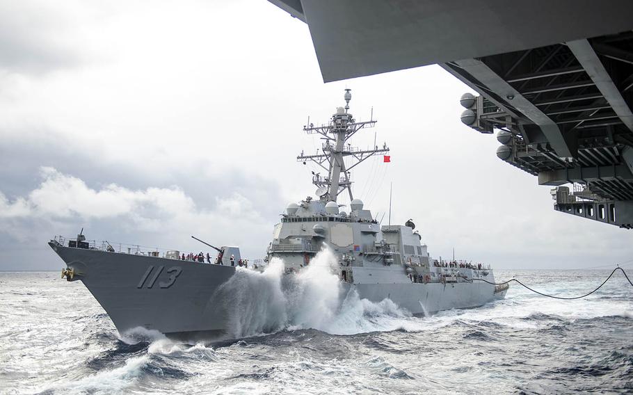 The guided-missile destroyer USS John Finn approaches the aircraft carrier USS Theodore Roosevelt for a replenishment-at-sea somewhere in the Pacific Ocean, Jan. 14, 2021. 