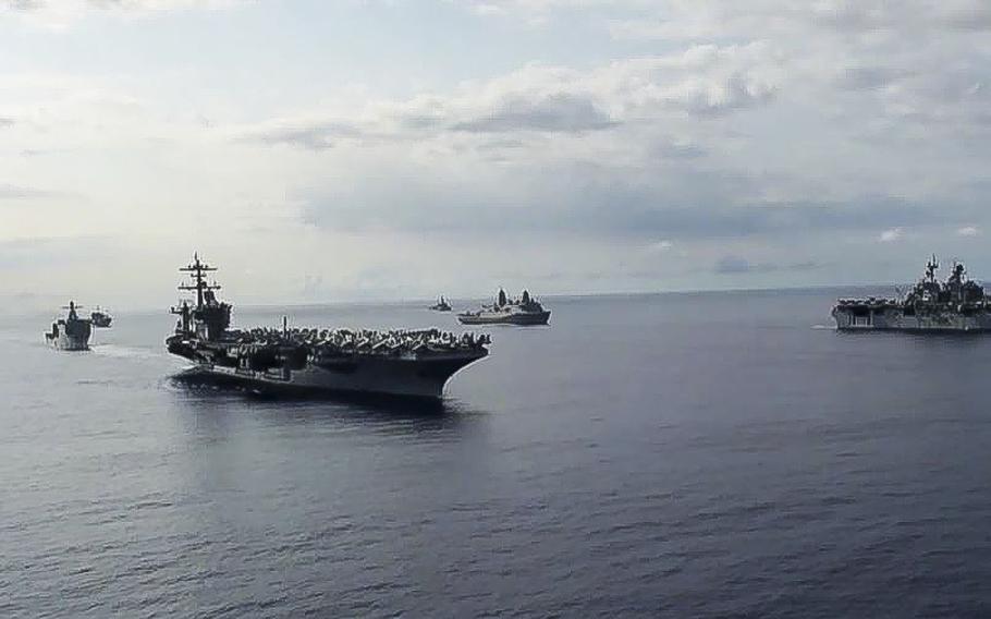 A video screen grab shows Ships from the Theodore Roosevelt Carrier Strike Group, the America Expeditionary Strike Group, and the U.S. 7th Fleet command ship, USS Blue Ridge (LCC 19), transit the Philippine Sea on March 24, 2020. The Roosevelt's commanding officer, Capt. Brett Crozier, has alerted the Navy that the aircraft carrier is facing a growing outbreak of the coronavirus.