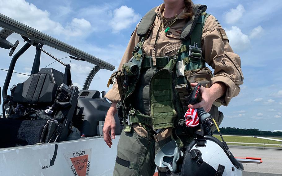 U.S. Navy Lt. Rhiannon Ross, an instructor pilot, stands in front of a T-6B Texan II primary flight trainer aircraft at Naval Air Station Whiting Field in Milton, Fla., in an undated photo. Ross and U.S. Coast Guard Ensign Morgan Garrett, a student naval aviator, died Oct. 23, 2020 when their aircraft crashed in Foley, Ala.