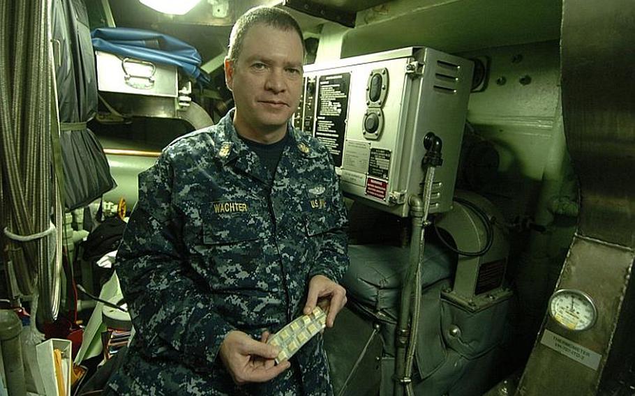 Chief Petty Officer Mark Wachter sits with a pack of nicotine chewing gum in what used to be a designated smoking area aboard the fast-attack submarine USS Charlotte, during a port visit Thursday at Yokosuka Naval Base, Japan. 