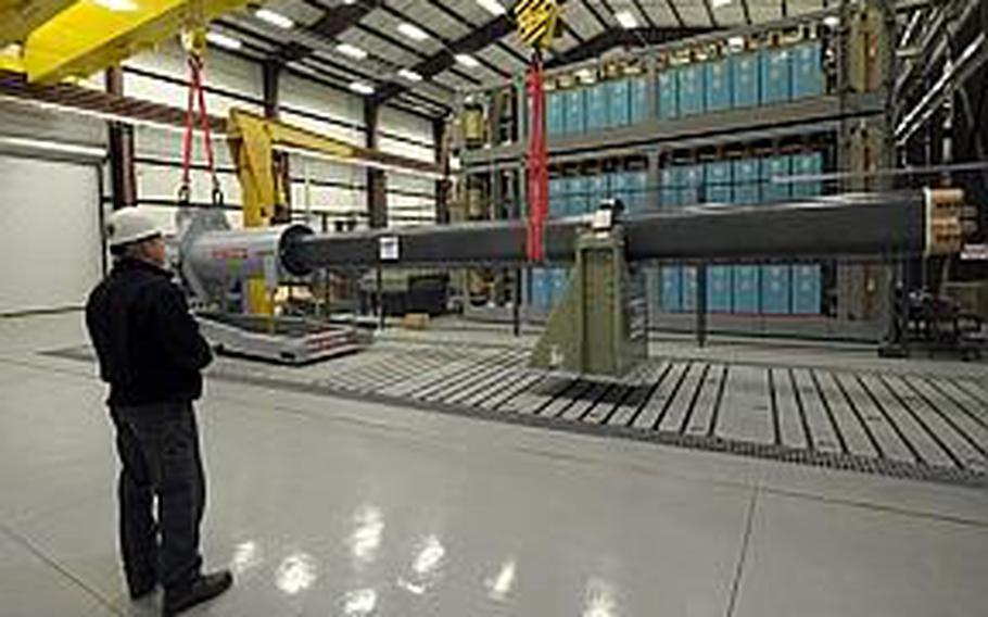 Gary Bass, of the Naval Surface Warfare Center in Dahlgren, Va., watches as a 32-MJ version of the electromagnetic railgun prototype is placed for testing. The railgun may someday be used to launch projectiles off ships at speeds over 5,000 mph.