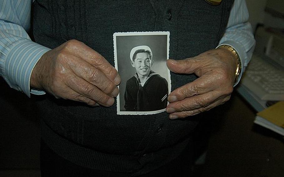 Mike Yoneda has plenty of mementos from his 63 years of service to the U.S. Navy, including this photo of him in his "Cracker Jack suit" shortly after joining the Navy in 1949. After retiring from active duty, he gave more than 30 years of service as a civilian to Sasebo Naval Base, and had a hand in many of the projects and programs that sailors and their families enjoy today.