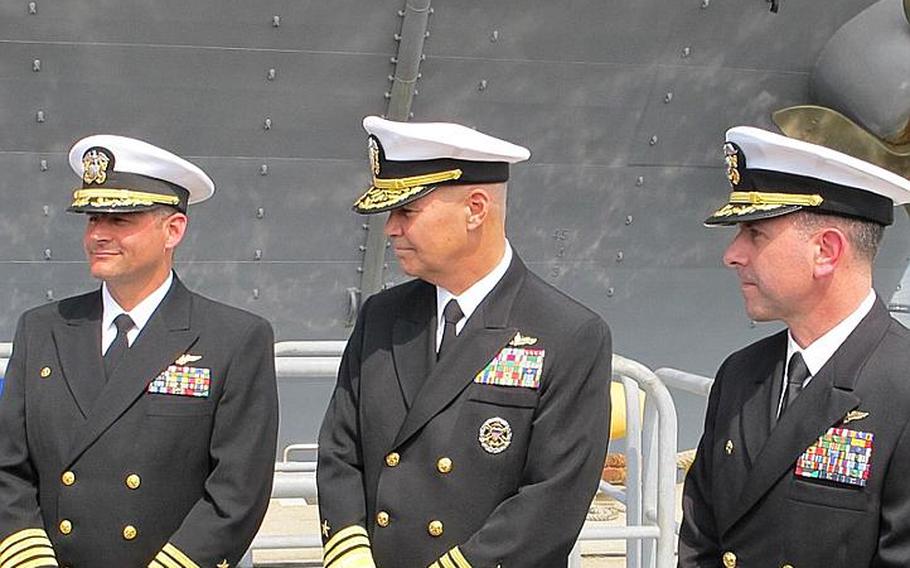 From left to right, Capt. Chuck Litchfield, formerly of the Bonhomme Richard, Vice Admiral Richard W. Hunt, Commander, Naval Surface Force, U.S. Pacific Fleet, and Capt. David Fluker, formerly of the USS Essex and now of the USS Bonhomme Richard. Fluker and Litchfield swapped ships April 23, 2012, during what is called a hull swap at Sasebo Naval Base.
