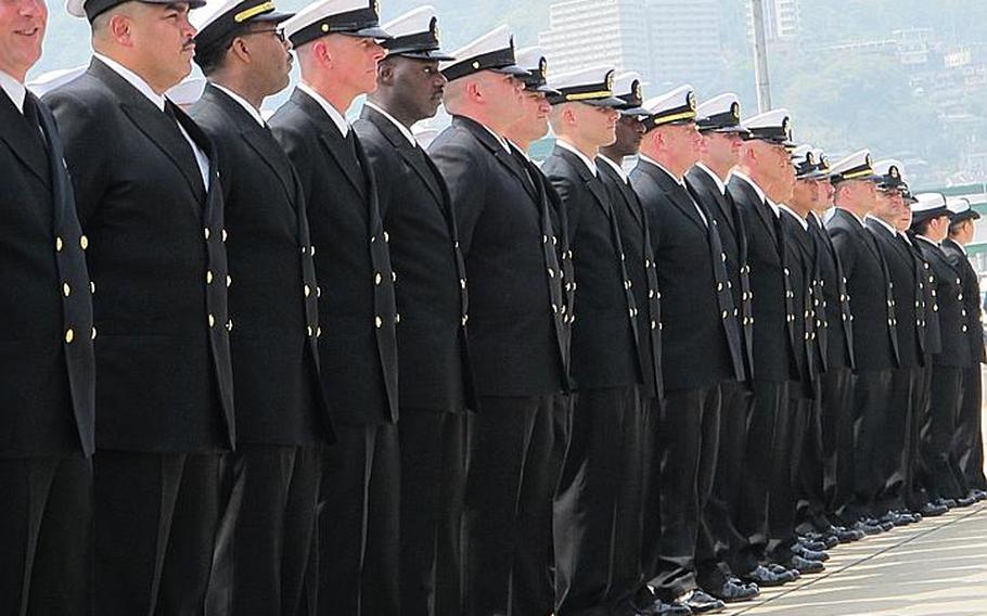 Officers of the USS Essex and Bonhomme Richard watch the hull swap ceremony April 23, 2012, at Sasebo Naval Base.