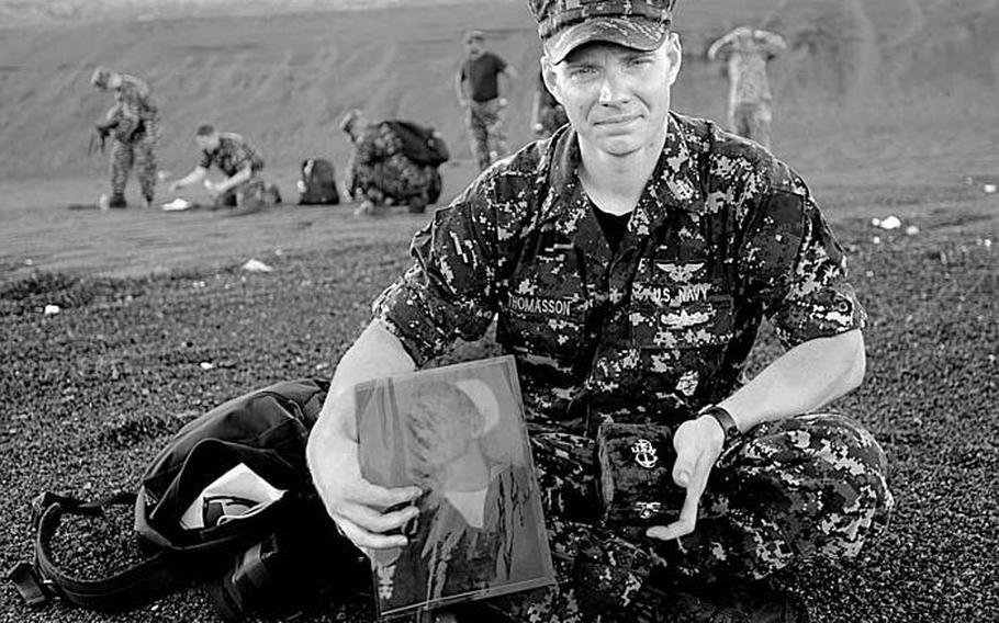 Chief Petty Officer Andrew Thomasson and his grandfather, Oscar Thomasson, share one last moment together Aug. 28, 2012, on Iwo Jima's Invasion Beach. Thomasson laid his grandfather's ashes to rest on the same beach a young Petty Officer 2nd Class Oscar Thomasson swam to after his landing craft was destroyed during the U.S. assault on the island during WWII.