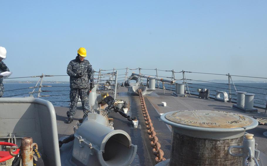 A sailor from the destroyer USS Curtis Wilbur observes as the anchor drops while at sea, east of Japan, during preparations for a Navy Board of Inspection and Survey review. The destroyer is 1 of the Navy's ballistic missile defense-capable ships based in Japan and could be among the 1st to know if North Korea were to launch a ballistic missile.