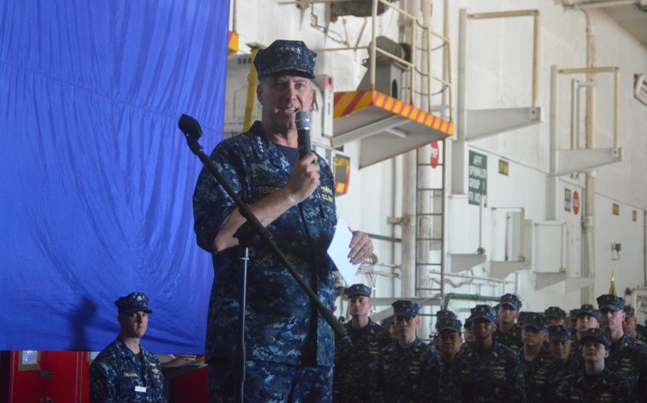 Adm. Mark Ferguson, the vice chief of naval operations, talks with sailors on the hangar deck of the aircraft carrier USS George Washington at Yokosuka Naval Base, Japan, on Aug. 28, 2013. Ferguson talked mainly about the potential effect of federal budget cuts under sequestration, as well as the military's need to reduce sexual assault incidents.