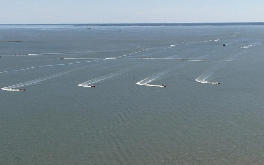 In a screen capture from video, eight unmanned high-speed maneuvering surface targets (HSMSTs) move to their blocking positions during an Office of Naval Research (ONR)-sponsored demonstration of autonomous swarmboat technology held on the James River in Newport News, Va. During the demonstration as many as 13 Navy boats, using an ONR-sponsored system called CARACaS (Control Architecture for Robotic Agent Command Sensing), operated autonomously or by remote control during escort, intercept and engage scenarios.
