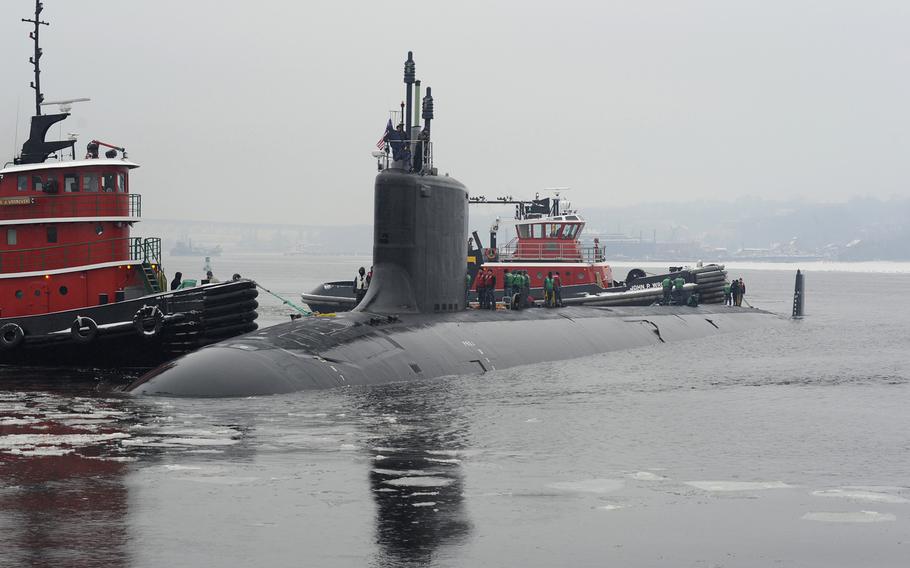 The first woman to serve aboard a Virginia-class fast-attack submarine reported last week to the USS Minnesota, pictured here arriving at its homeport in Groton, Conn. Six women, all officers, are joining the crews of the Minnesota and the USS Virginia in 2015.