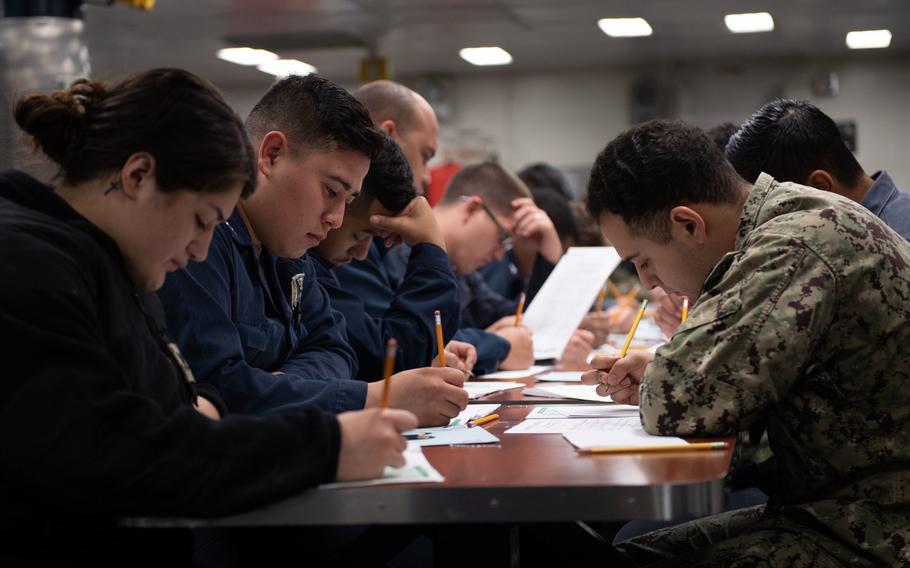 Sailors aboard amphibious assault ship USS Boxer take the navy-wide E-5 advancement exam on the ships mess decks in March 2020 in San Diego. The Navy has canceled fall Petty Officer 3rd Class advancement exams to limit exposure to coronavirus.