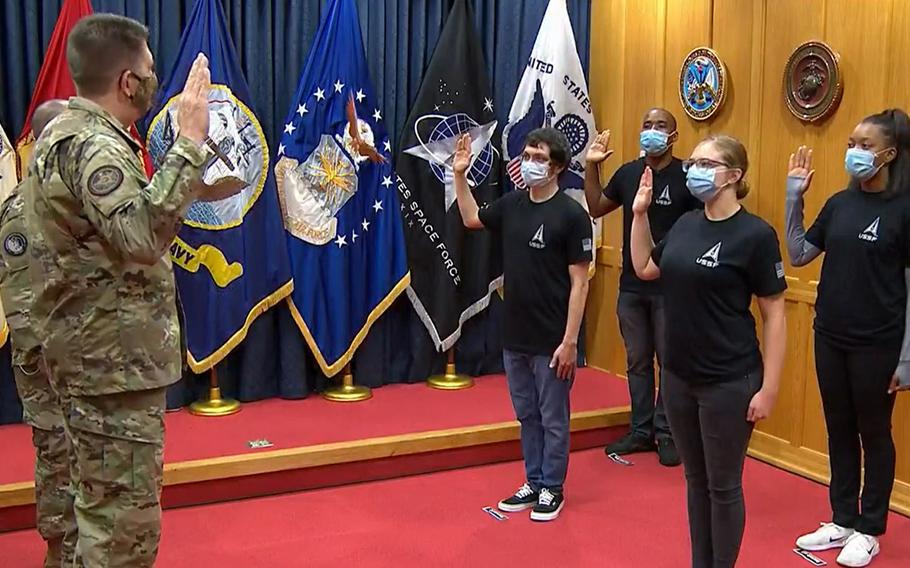 In this image from video streamed on social media, Gen. David Thompson, the vice chief of space operations, swears in Space Force's first recruits Tuesday, Oct. 20, 2020, at Baltimore Military Entrance Processing Station at Fort Meade, Md.