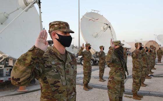 U.S. Air Force company grade officers raise their hands during an oath of office ceremony at Al Udeid Air Base in Qatar as they transferred into the Space Force on Sept. 1, 2020. The Space Force is the United States' newest service in more than 70 years. 
