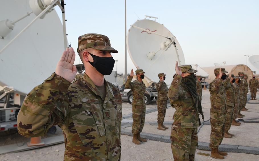 U.S. Air Force company grade officers raise their hands during an oath of office ceremony at Al Udeid Air Base in Qatar as they transferred into the Space Force on Sept. 1, 2020. 