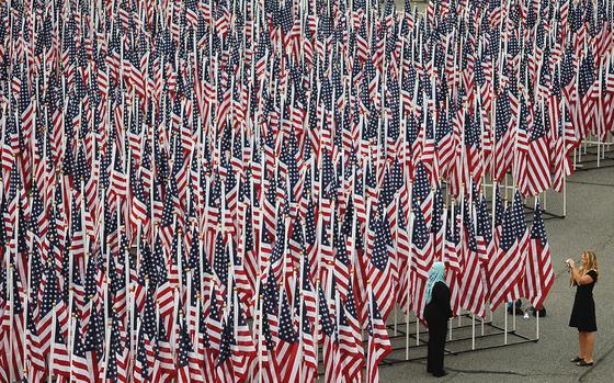 enw# 61p cs
Robin Hoecker/Stars and Stripes
2298 flags representing the lives lost on 9/11 stood in the Pentagon parking lot for the memorial dedication ceremony.