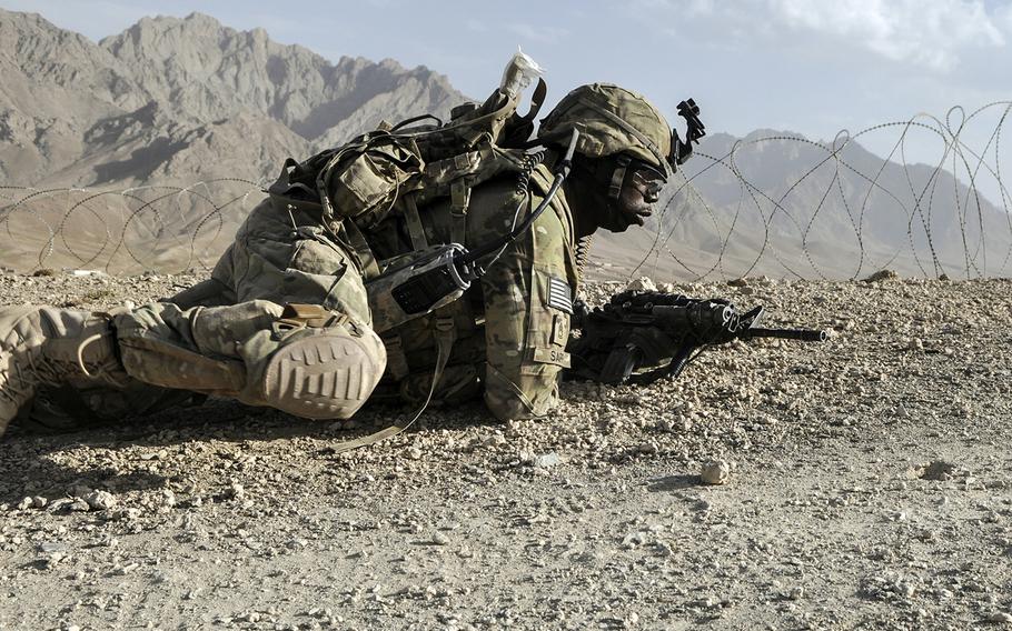 107p cs
Sgt. 1st Class Trederick Sapp, of Headquarters and Headquarters
Company, 4th Brigade of the 10th Mountain Division, crawls toward the camp perimeter to scan for insurgents after a firefight .
Neil Shea/Stars and Stripes