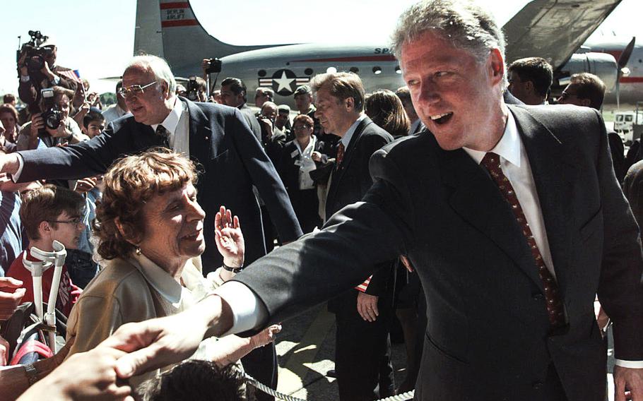 Then-President Bill Clinton shakes hands with the locals after a ceremony renaming an Air Force C-17 “The Spirit of Berlin” in Berlin, Germany on May 14, 1998.