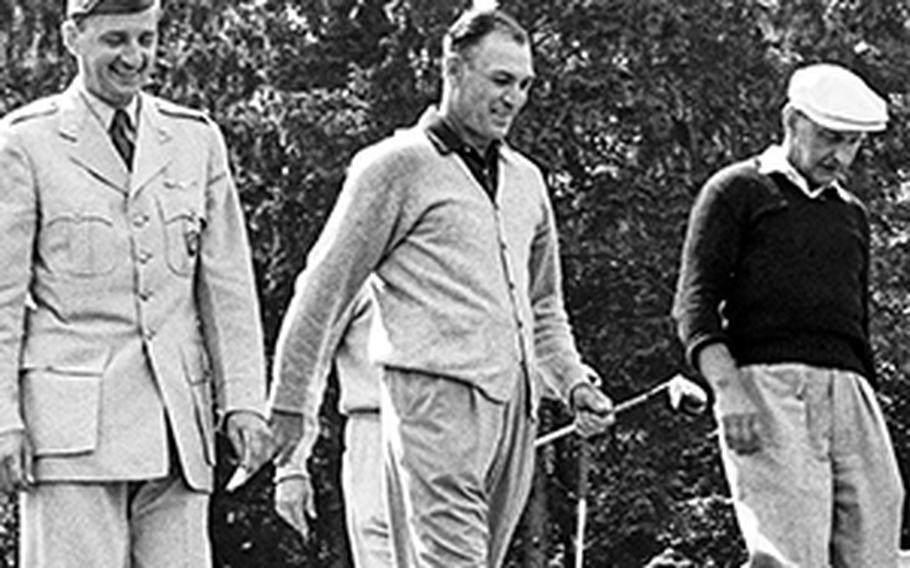 Ben Hogan plays golf at Wiesbaden, 1956
Gene Bane ©Stars and Stripes
Wiesbaden, West Germany, July 3, 1956: Golfing great Ben Hogan, center, is joined by match referee Lt. Col. Bill Quinlan of SHAPE, left, and playing partner John Urban as he starts down the fairway after teeing off in an exhibition round at the Wiesbaden Area Command golf course. Hogan delighted the crowd of 1,500 spectators by shooting a one-under-par 34 in the nine-hole match despite never having seen the course.