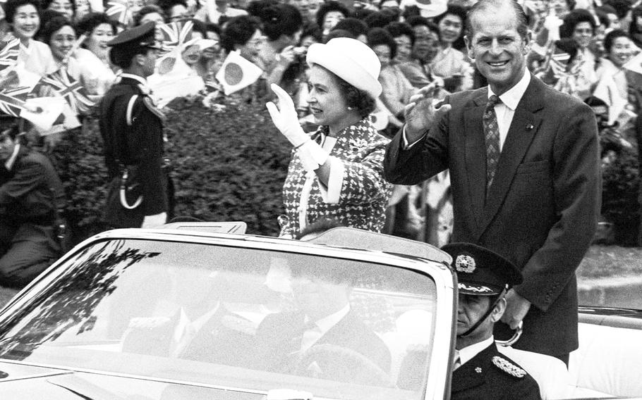Queen Elizabeth II and Prince Philip of England wave to the crowd in May of 1975 as they ride from the Imperial Hotel to the National Theater. With her six-day visit, Elizabeth became the first reigning British monarch to go to Japan. Philip, the Duke of Edinburgh, died April 9, 2021, at age 99.