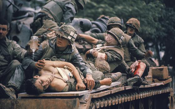 A.B. Grantham, foreground, and other wounded U.S. Marines are evacuated on a tank at Hue, South Vietnam, during the Tet offensive in February 1968. 