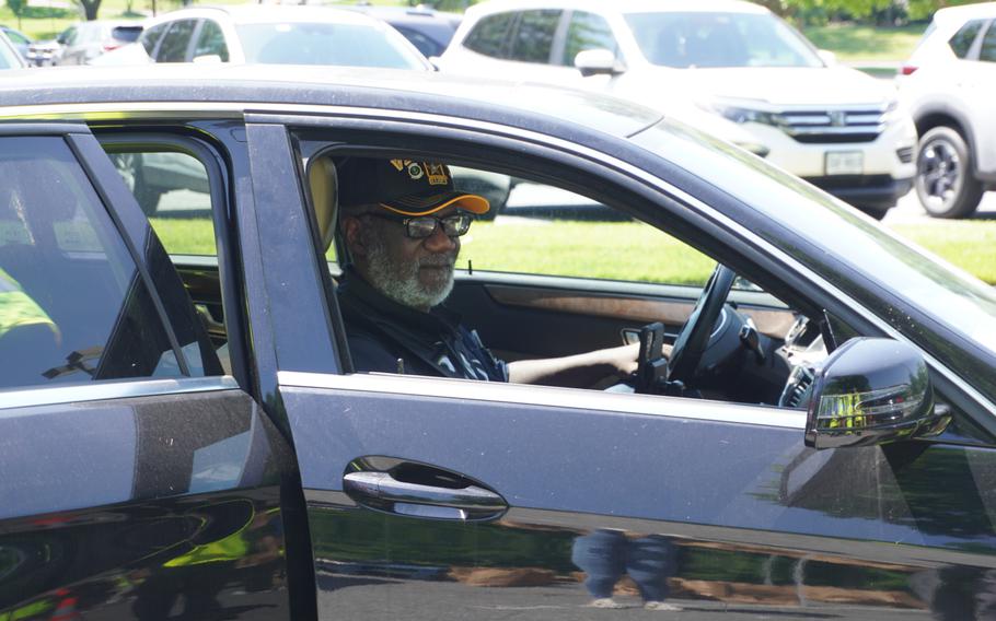 A man smiles in a car