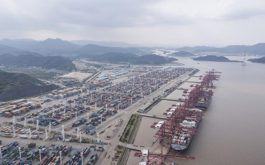 Containers sit stacked next to gantry cranes in this aerial photograph taken above the Port of Ningbo-Zhoushan in Ningbo, China, on Oct. 31, 2018.
