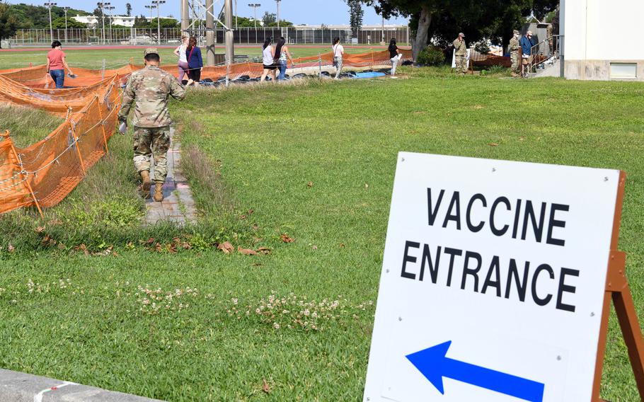 Service members and civilians wait to receive the COVID-19 vaccine earlier this spring at Kadena Air Base, Okinawa. 