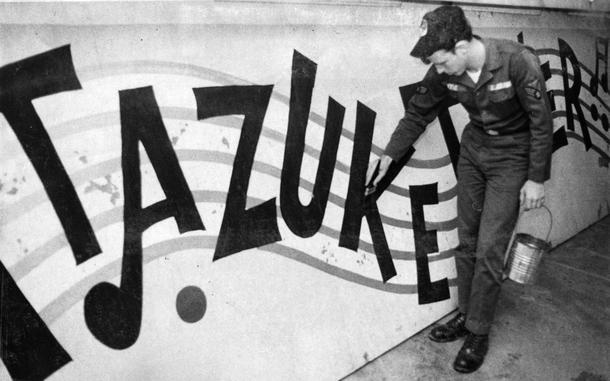 Itazuke Air Base, Fukuoka, Japan, June 1971: The old Itazuke Tower sign is getting a new paint job by an airman assigned to the southern Japan base. The five-foot high, 18-foot long, half-ton sign became famous during the Korean War when the “Itazuke Tower” song was published. Curious about the song? Head on over here to hear the song https://www.youtube.com/watch?v=3ZtCnJKih_8 Check out Stars and Stripes' historic newspaper archive for more of our 1971 content https://starsandstripes.newspaperarchive.com/  META TAGS: Pacific; Japan; Kyushu Island; Itazuke Airbase; art; signage; U.S Air Force