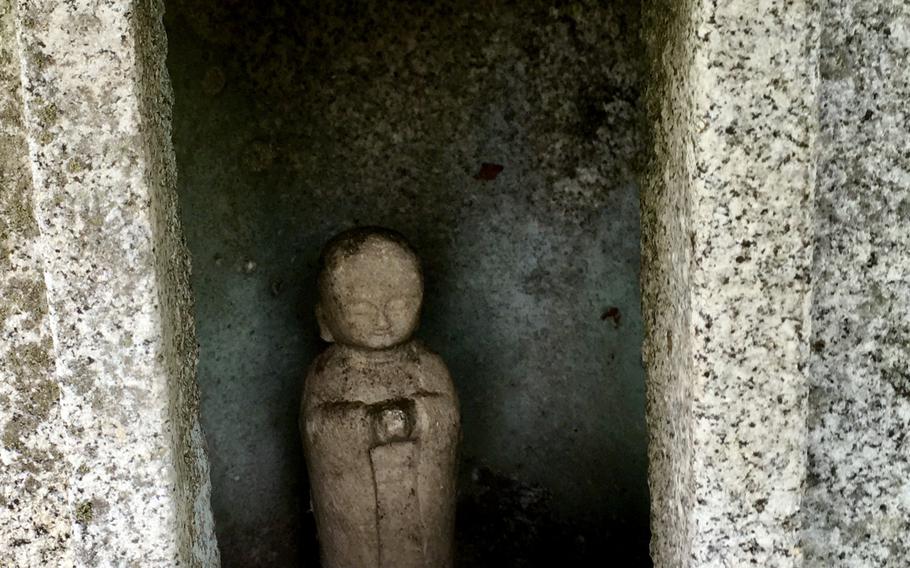 A figurine in the summit shrine at Mount Hinokiboramaru in western Kanagawa prefecture, Japan, welcomes visitors.
