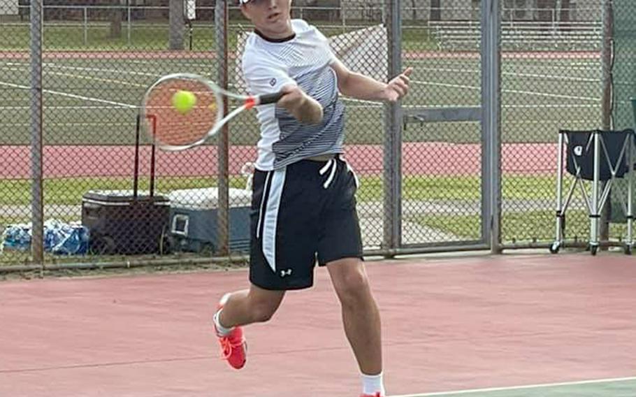 Senior Liam Hunter drives a forehand smash during Friday's Japan tennis matches at Misawa Air Base. Hunter won both his singles matches and teamed with Gabe Rayos to win their doubles matches.