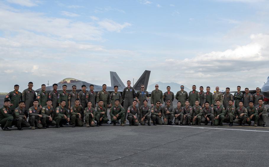 U.S. and Philippine airmen pose with an Air Force F-22 Raptor at Clark Air Base, Philippines, in this photo tweeted by the U.S. Embassy, Thursday, March 16, 2023.