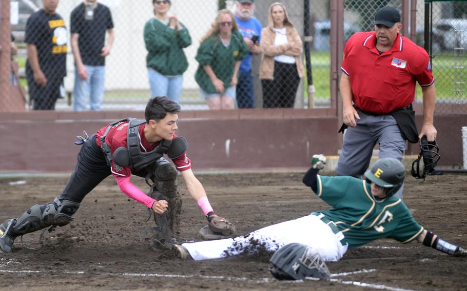 Edgren's Levi Kuns slides in safe at home ahead of the tag by Perry's Taisei Shimakura.