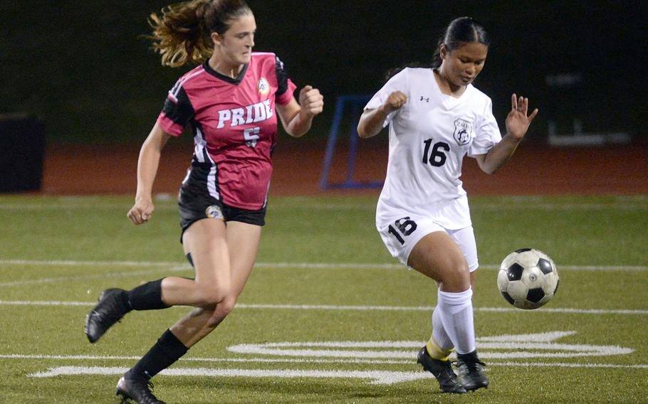 Kadena's Emma Simpson chases Zama's Raely Flores with the ball during Friday's All-DODEA-Japan soccer tournament quarterfinal. The Panthers edged the Trojans 1-0.