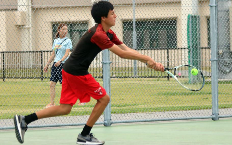 E.J. King's Christian Garcia lunges for a backhand against E.J. King during Saturday's DODEA-Japan tennis matches. Garcia lost his singles match 8-3 to Matthew C. Perry's Max Bailey, and teamed later with David Axsom in doubles, in which they lost 8-4 to Bailey and Layne Mayer of Perry.