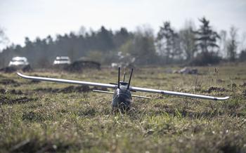 A 3D printed drone lies in a field.
