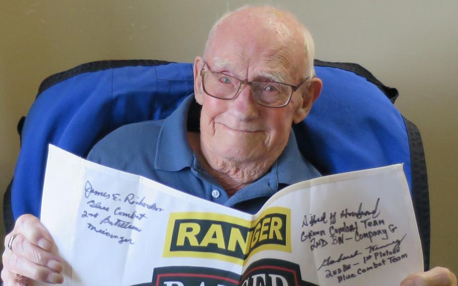 Raleigh Nayes in 2020 holds a battalion flag belonging to Army Ranger Cory Remsburg, who was wounded in 2009 in Afghanistan. The flag was signed by the nine still-living Merrill’s Marauders veterans and returned to Remsburg.